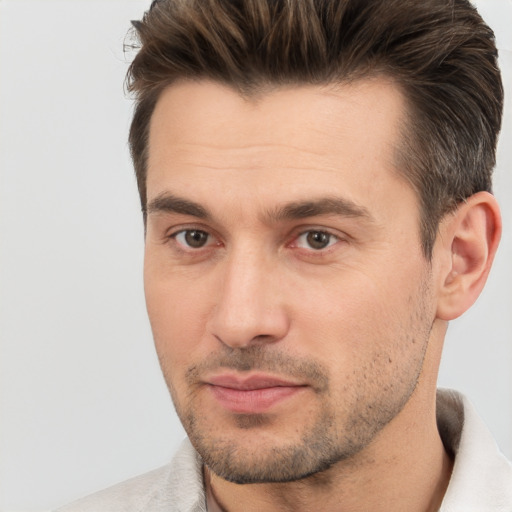 Joyful white adult male with short  brown hair and brown eyes