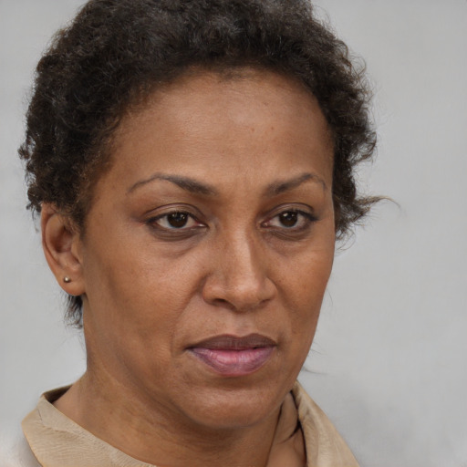 Joyful black adult female with short  brown hair and brown eyes