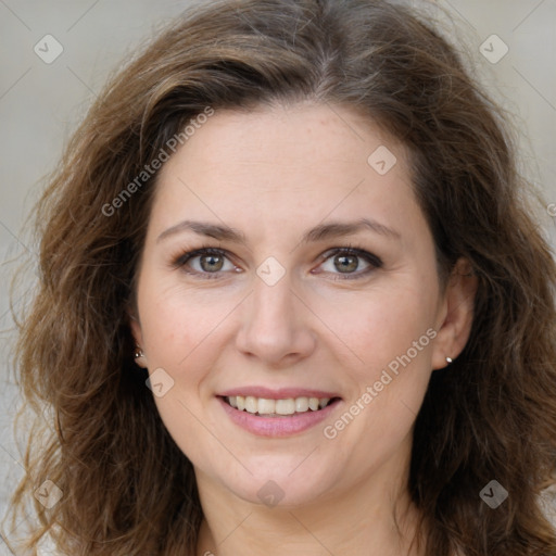 Joyful white adult female with long  brown hair and brown eyes