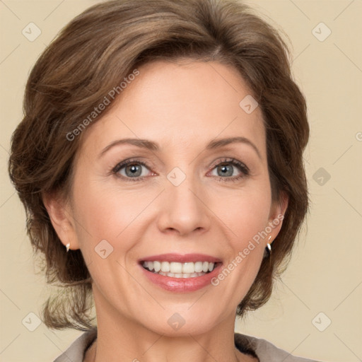 Joyful white adult female with medium  brown hair and green eyes