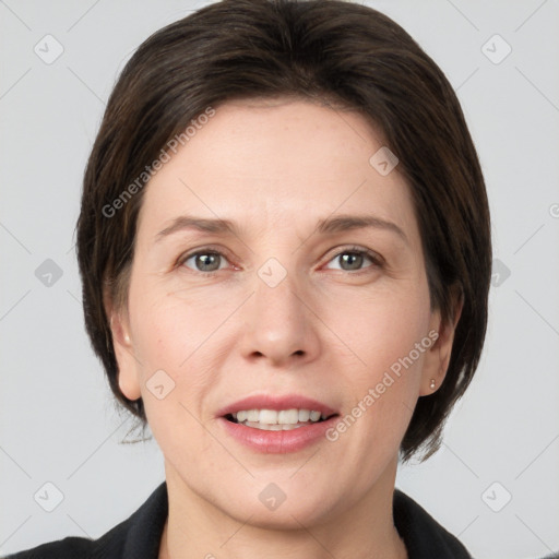 Joyful white young-adult female with medium  brown hair and grey eyes