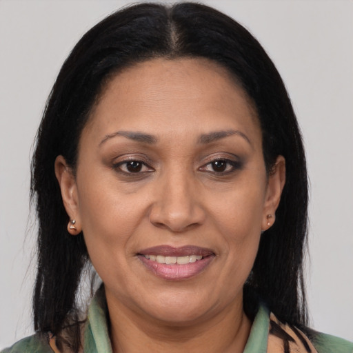 Joyful latino adult female with medium  brown hair and brown eyes