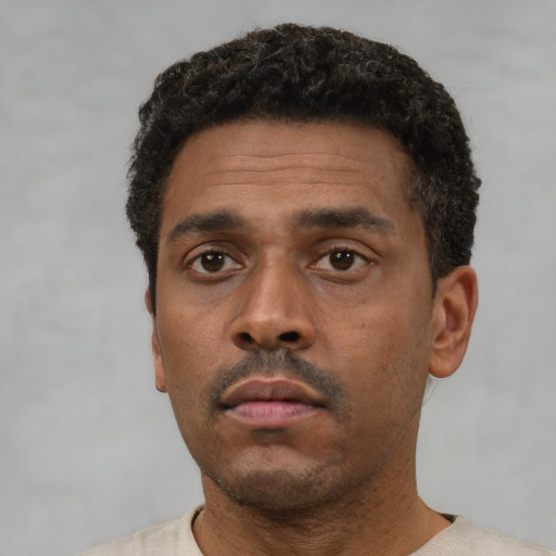 Neutral black young-adult male with short  black hair and brown eyes
