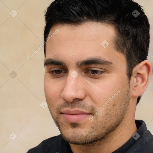 Joyful white young-adult male with short  black hair and brown eyes