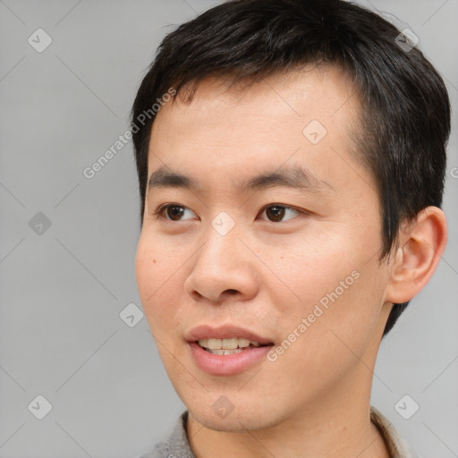 Joyful asian young-adult male with short  brown hair and brown eyes