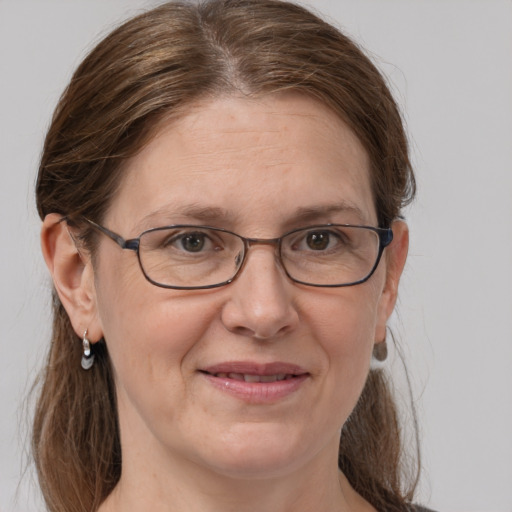 Joyful white adult female with medium  brown hair and grey eyes