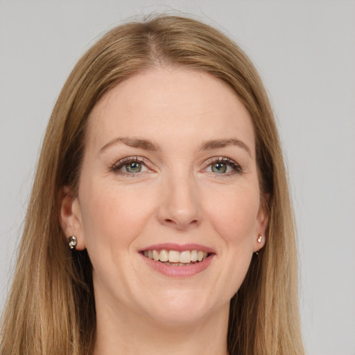 Joyful white young-adult female with long  brown hair and green eyes