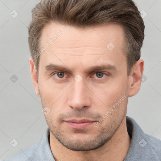 Neutral white adult male with short  brown hair and grey eyes