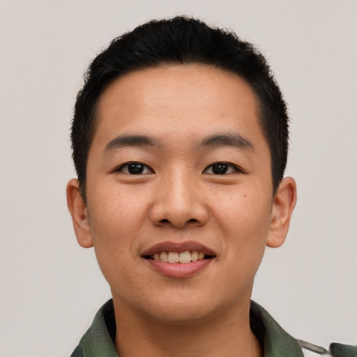 Joyful asian young-adult male with short  black hair and brown eyes