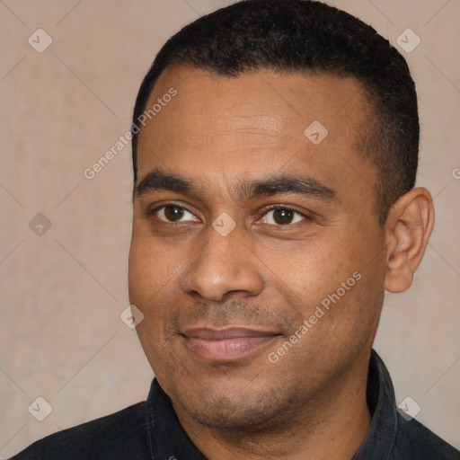 Joyful latino young-adult male with short  black hair and brown eyes