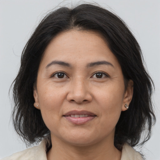 Joyful asian adult female with medium  brown hair and brown eyes