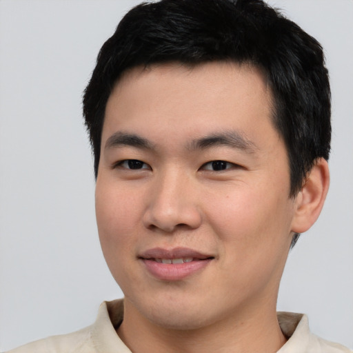 Joyful asian young-adult male with short  black hair and brown eyes