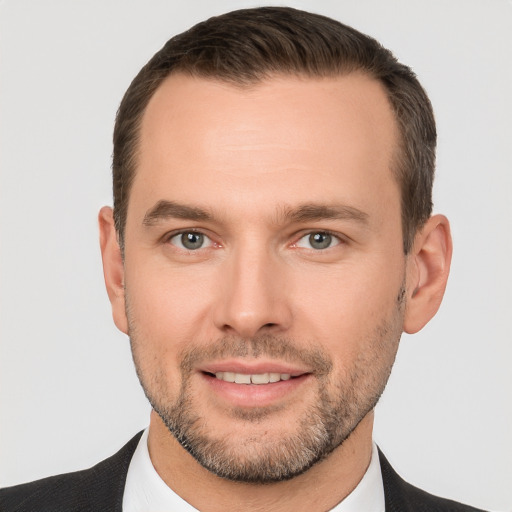 Joyful white young-adult male with short  brown hair and brown eyes