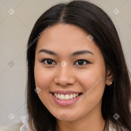 Joyful latino young-adult female with long  brown hair and brown eyes