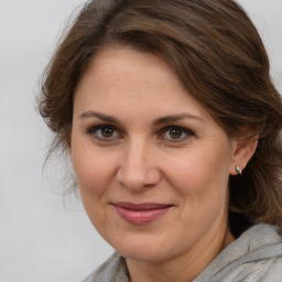 Joyful white adult female with medium  brown hair and brown eyes