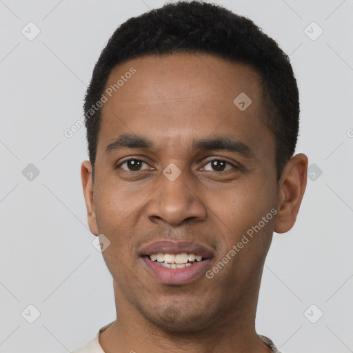 Joyful black young-adult male with short  black hair and brown eyes