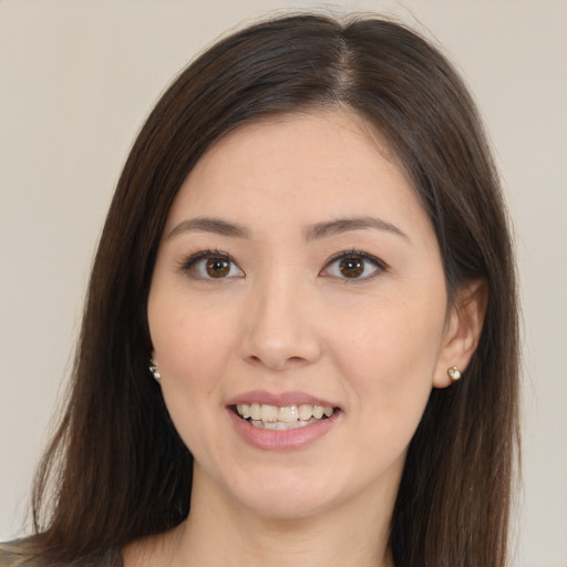 Joyful white young-adult female with long  brown hair and brown eyes