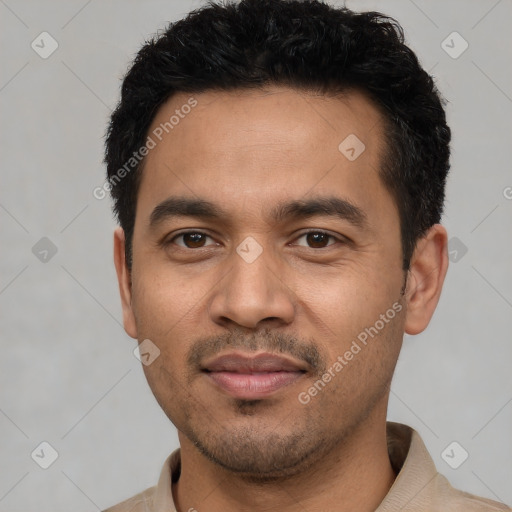 Joyful latino young-adult male with short  black hair and brown eyes