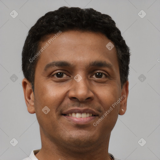 Joyful black young-adult male with short  brown hair and brown eyes