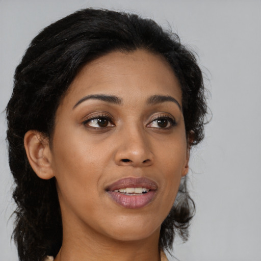 Joyful black young-adult female with medium  brown hair and brown eyes