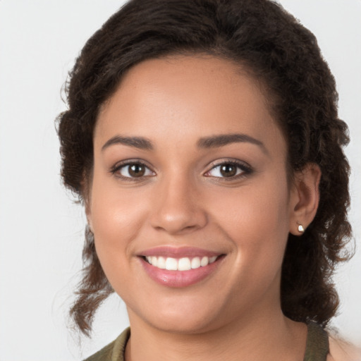 Joyful white young-adult female with long  brown hair and brown eyes