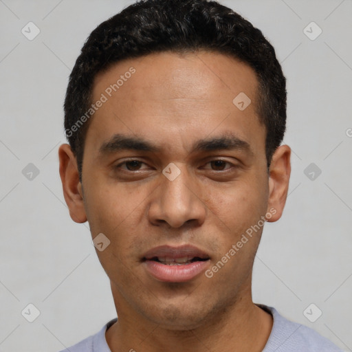 Joyful latino young-adult male with short  black hair and brown eyes