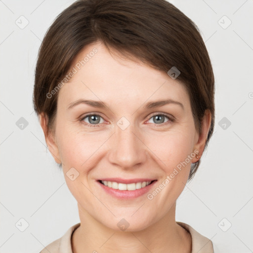 Joyful white young-adult female with short  brown hair and grey eyes