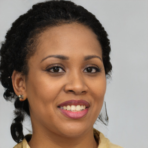 Joyful black young-adult female with medium  brown hair and brown eyes