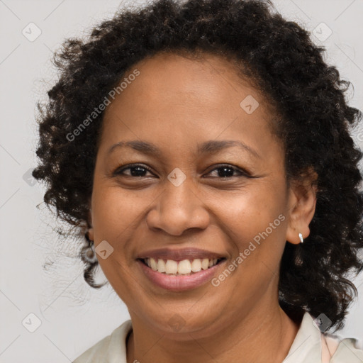 Joyful black adult female with medium  brown hair and brown eyes