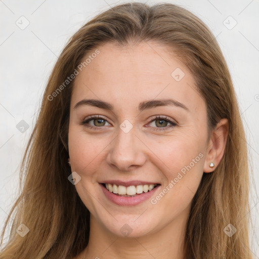 Joyful white young-adult female with long  brown hair and green eyes