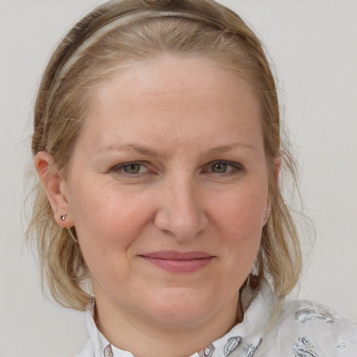 Joyful white adult female with medium  brown hair and blue eyes