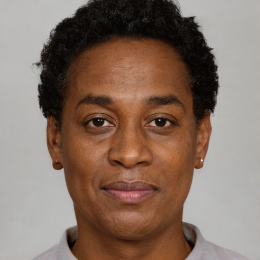 Joyful black adult male with short  brown hair and brown eyes