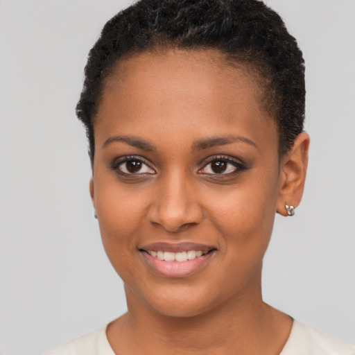 Joyful black young-adult female with short  brown hair and brown eyes
