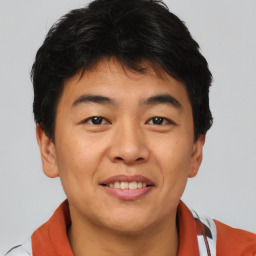 Joyful asian young-adult male with short  brown hair and brown eyes