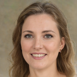 Joyful white young-adult female with medium  brown hair and green eyes