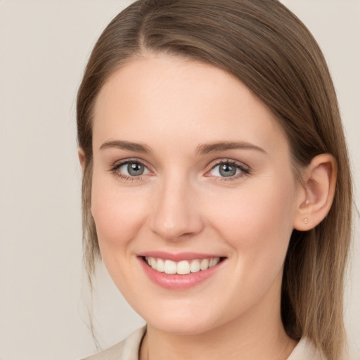 Joyful white young-adult female with long  brown hair and grey eyes