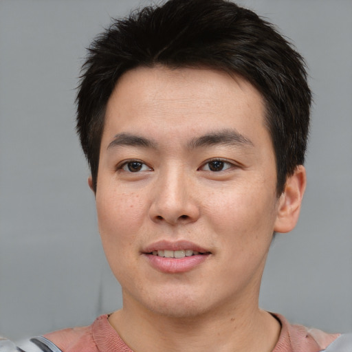 Joyful asian young-adult male with short  brown hair and brown eyes