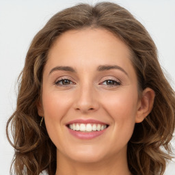 Joyful white young-adult female with long  brown hair and green eyes