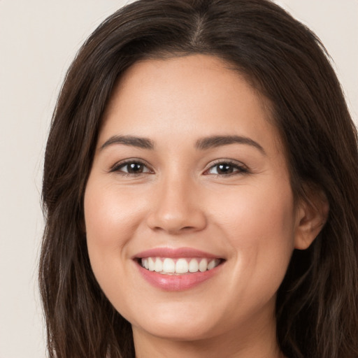 Joyful white young-adult female with long  brown hair and brown eyes