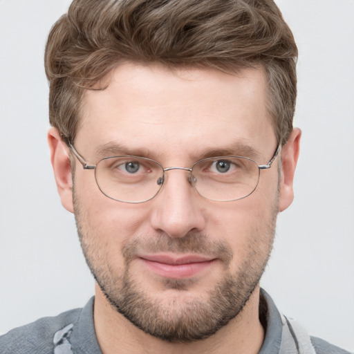 Joyful white adult male with short  brown hair and blue eyes