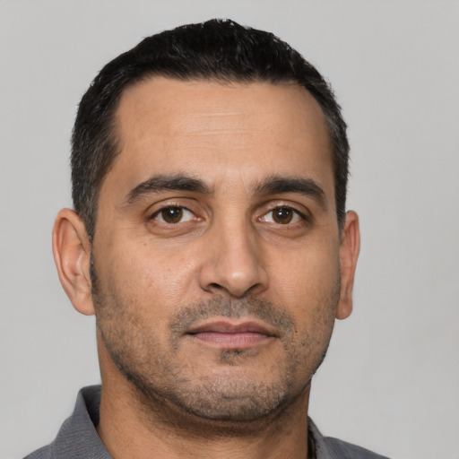 Neutral white adult male with short  black hair and brown eyes