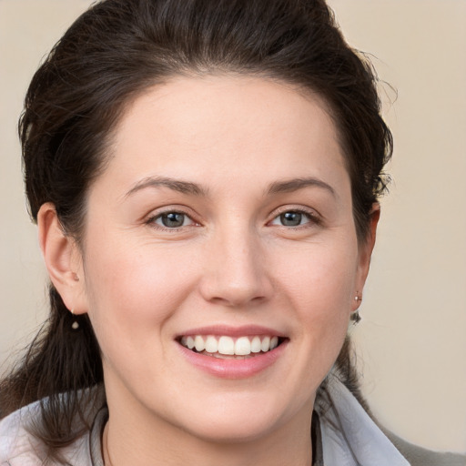 Joyful white young-adult female with medium  brown hair and brown eyes