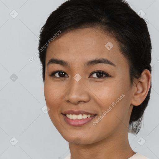 Joyful asian young-adult female with medium  brown hair and brown eyes