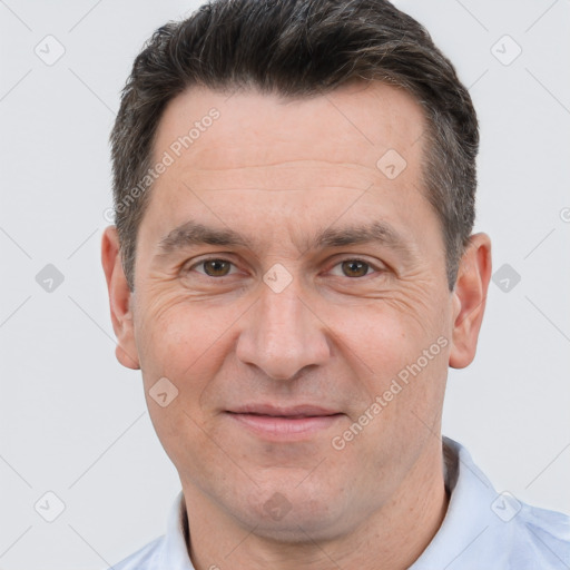 Joyful white adult male with short  brown hair and brown eyes