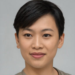 Joyful asian young-adult female with short  black hair and brown eyes