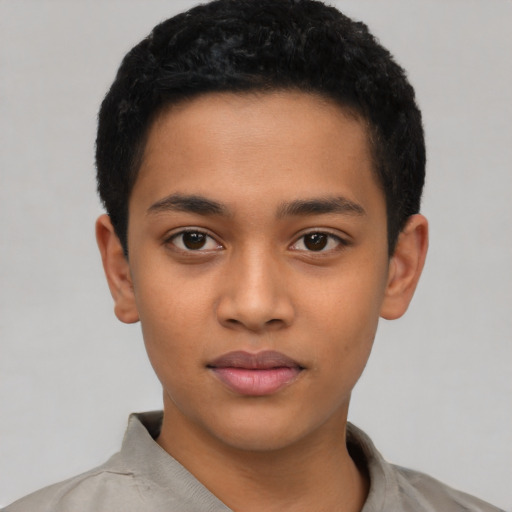 Joyful latino child male with short  black hair and brown eyes