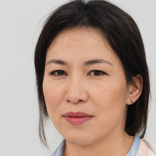 Joyful asian adult female with medium  brown hair and brown eyes