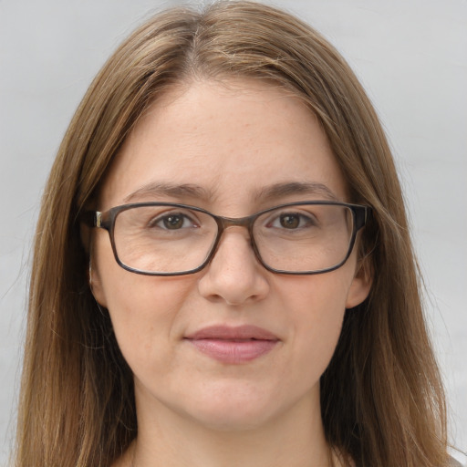 Joyful white adult female with long  brown hair and brown eyes