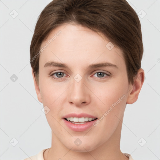 Joyful white young-adult female with short  brown hair and grey eyes