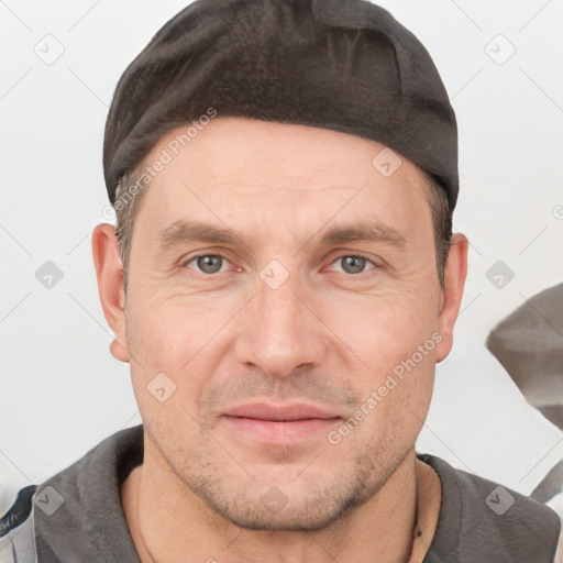 Joyful white adult male with short  brown hair and brown eyes